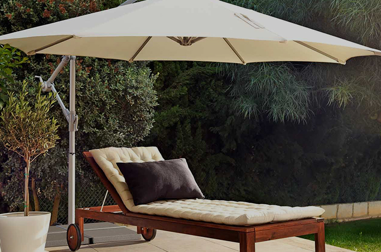 How does the material of Patio Umbrellas affect durability and sun protection?